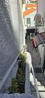 a small garden on the side of a building at Great Stay 1 Bedroom Funchal Central Duplex Retreat in Funchal