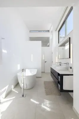 a bathroom with a black and white geometric wall at Vila Golfinho, with heated pool, rooftop lounge and ocean views in Luz