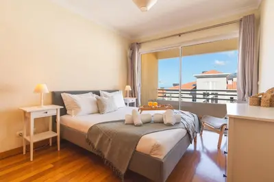 a bedroom with a bed and a large window at Sunny Stay Green Park by Atlantic Holiday in Panasqueira