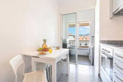 a white kitchen with a white table and chairs at Sunny Stay Green Park by Atlantic Holiday in Panasqueira