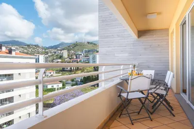 a balcony with two chairs and a table on it at Sunny Stay Green Park by Atlantic Holiday in Panasqueira