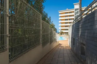 a walkway next to a fence next to a pool at Sunny Stay Green Park by Atlantic Holiday in Panasqueira