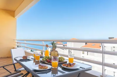 a table with food and drinks on a balcony at Sunny Stay Green Park by Atlantic Holiday in Panasqueira