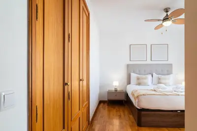 a bedroom with a bed and a ceiling fan at GuestReady – Scenic Stay in the Heart of Funchal in Funchal