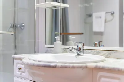 a bathroom with a sink and a mirror at GuestReady – Scenic Stay in the Heart of Funchal in Funchal