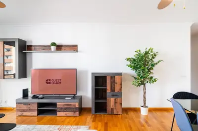 a living room with a tv and a table at GuestReady – Scenic Stay in the Heart of Funchal in Funchal