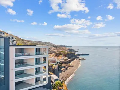 an apartment building with a view of the ocean at Atlantis Apartment in Câmara de Lobos