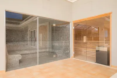 a large glass shower in a room with a kitchen at Boa Vista - Salo Apartment in Lagos