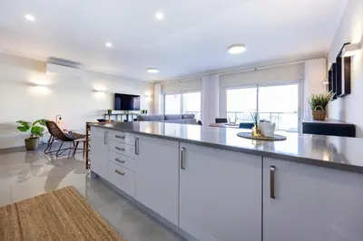 a kitchen with white cabinets and a large counter top at Boa Vista - Salo Apartment in Lagos
