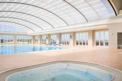 a large swimming pool with a domed ceiling at Boa Vista - Salo Apartment in Lagos
