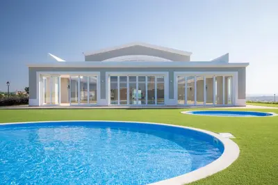 a house with a swimming pool in front of it at Boa Vista - Salo Apartment in Lagos