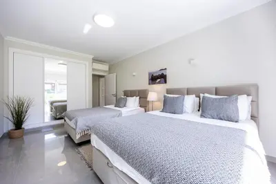 a bedroom with two beds and a large window at Boa Vista - Salo Apartment in Lagos