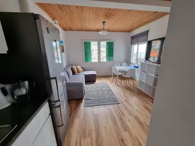 a living room with a couch and a table at Sunrise Valley in Machico