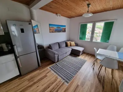 a living room with a couch and a refrigerator at Sunrise Valley in Machico