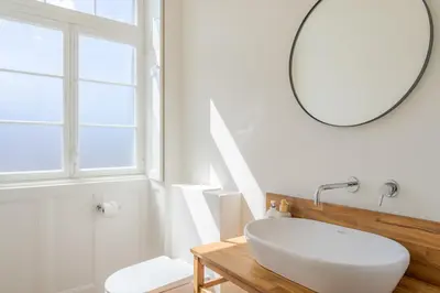 a bathroom with a white sink and a mirror at Luxury Quinta Rosa by Holiday Rental Madeira in Funchal