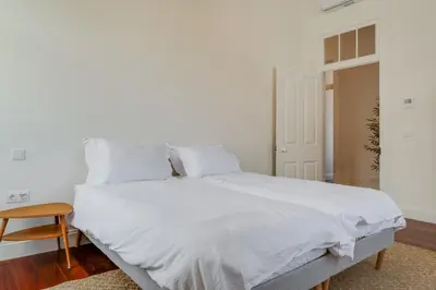 a white bed with white sheets and pillows at Luxury Quinta Rosa by Holiday Rental Madeira in Funchal