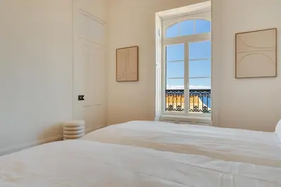 a white bedroom with a large bed and a window at Luxury Quinta Rosa by Holiday Rental Madeira in Funchal