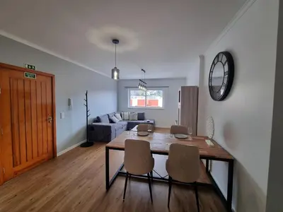 a dining room and living room with a table and chairs at Julianas Place by Susys Holidays in Funchal