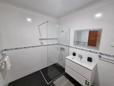 a white bathroom with a sink and a shower at Julianas Place by Susys Holidays in Funchal