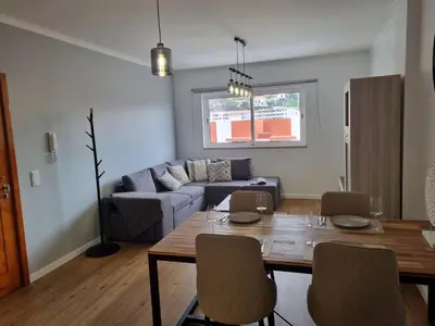 a living room with a table and a couch at Julianas Place by Susys Holidays in Funchal