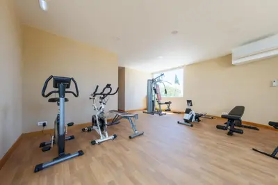 a gym with several exercise bikes and treadmills at Beach Condominium 28 by Destination Algarve in Atalaia