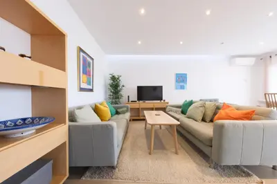 a living room with a couch and a table at Beach Condominium 28 by Destination Algarve in Atalaia