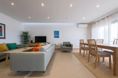 a living room with a couch and a table at Beach Condominium 28 by Destination Algarve in Atalaia