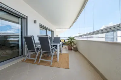 an empty balcony with a table and chairs on it at Beach Condominium 28 by Destination Algarve in Atalaia