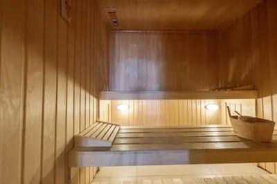 a sauna with wooden walls and a wooden bench at Beach Condominium 28 by Destination Algarve in Atalaia