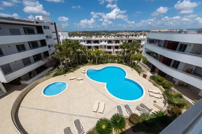 an overhead view of a swimming pool in the middle of two buildings at Beach Condominium 28 by Destination Algarve in Atalaia