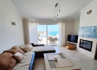a living room with a couch and a fireplace at Casa Calma in Salema