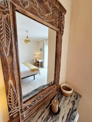 a mirror sitting on a table in a room at Casa Calma in Salema