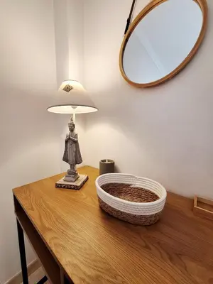 a table with a lamp and a mirror on it at Casa Calma in Salema