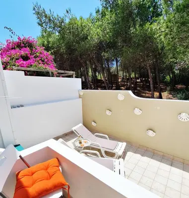 a balcony with a table and chairs and trees at Casa Calma in Salema