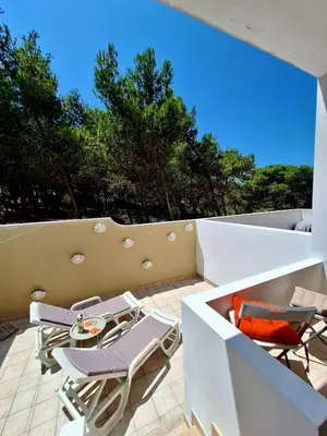 a patio with chairs and a table on a balcony at Casa Calma in Salema