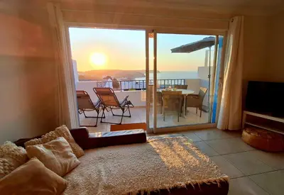 a living room with a view of a balcony at Casa Calma in Salema