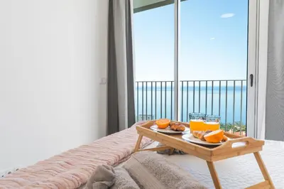 a tray of oranges on a table in a room with a window at Atlantic View Apartment by Atlantic Holiday in Câmara de Lobos
