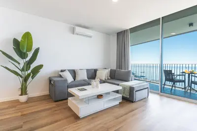 a living room with a couch and a table at Atlantic View Apartment by Atlantic Holiday in Câmara de Lobos