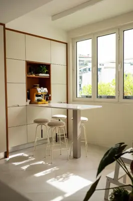 a kitchen with white cabinets and a stainless steel refrigerator at Madeira Precious Family Apartment in Funchal