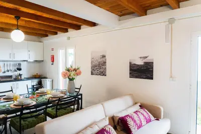 a living room with a couch and a table at Whale's Lodge in Porto Moniz