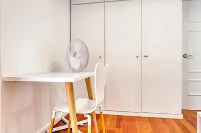a white table and chairs in a room with white cabinets at Baia Cliff View, a Home in Madeira in Funchal