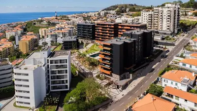 an aerial view of a city with buildings and the ocean at Horizon Funchal in Funchal