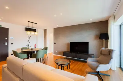 a living room with a couch and a table at Horizon Funchal in Funchal