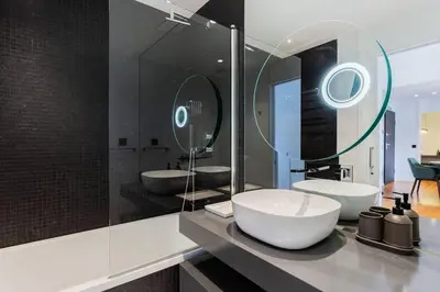 a bathroom with two sinks and a large mirror at Horizon Funchal in Funchal