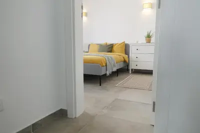 a bedroom with a bed with a yellow blanket at Endless Ocean - Praia da Luz in Luz