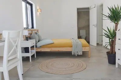 a bedroom with a bed and a desk and a chair at Endless Ocean - Praia da Luz in Luz