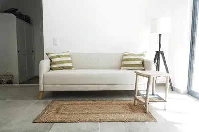 a living room with a white couch and a stool at Endless Ocean - Praia da Luz in Luz