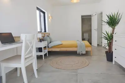 a bedroom with a bed and a desk with a laptop at Endless Ocean - Praia da Luz in Luz