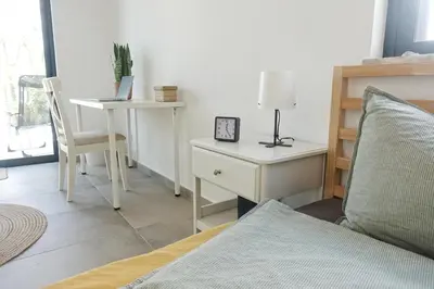 a bedroom with a bed and a desk with a laptop at Endless Ocean - Praia da Luz in Luz