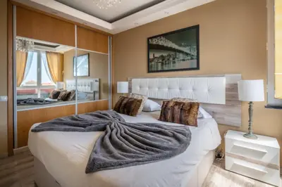 a bedroom with a large white bed with a blanket on it at America Apartment by Holiday Rental Madeira in Funchal